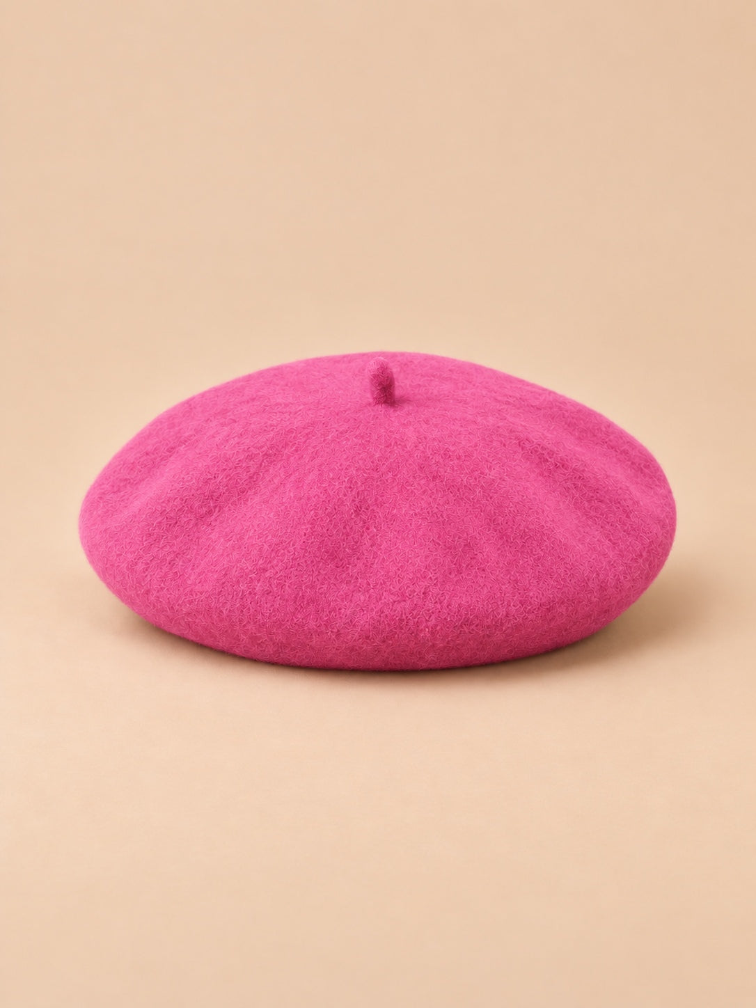 Béret d’artiste femme en laine mélangée vintage, coloris 006, vue de face sur fond sable pêche.