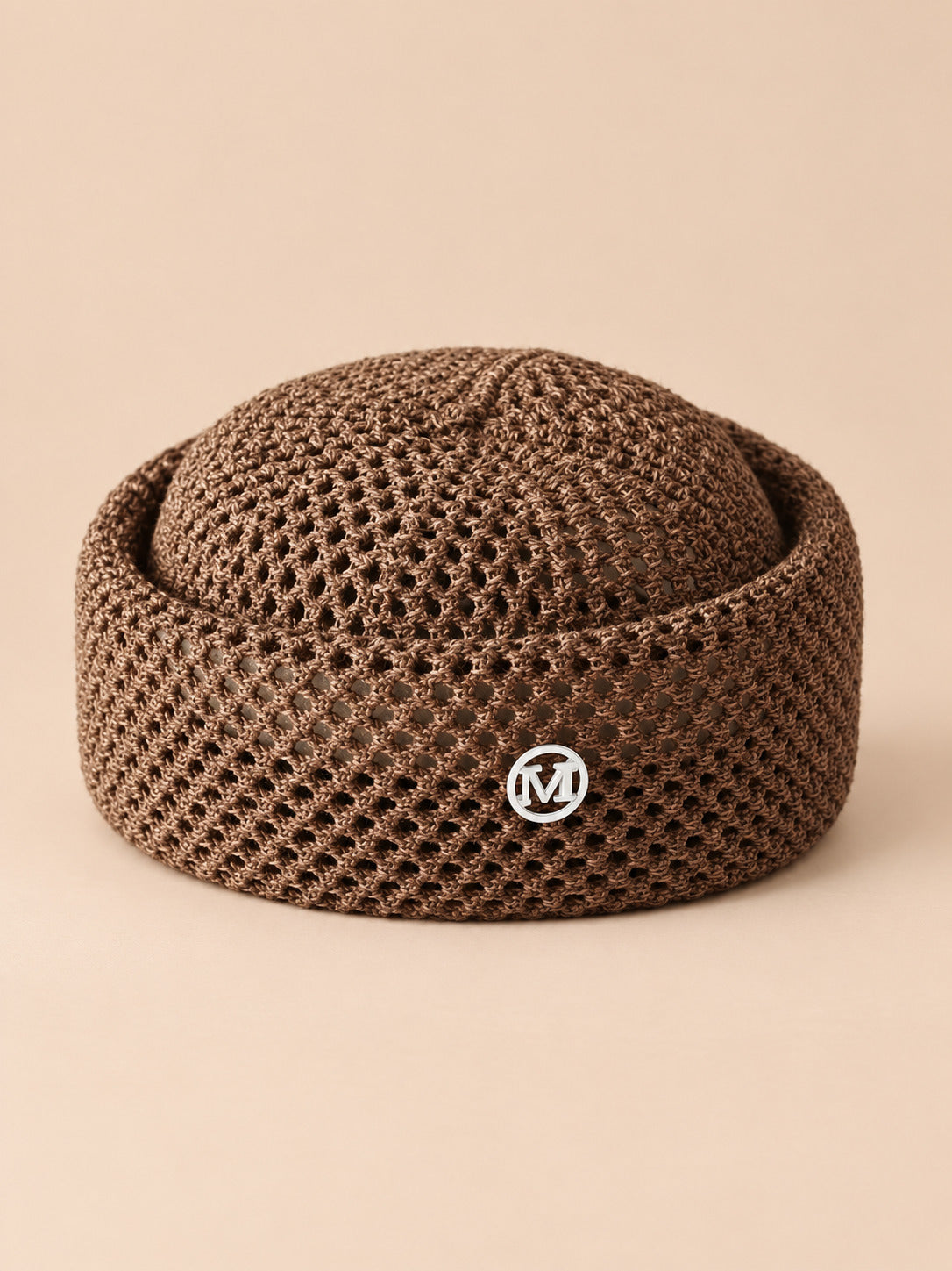 Béret rétro crochet Marron M, vue de face sur fond pêche sable