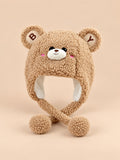 Gorro infantil de osito color café efecto peluche, con orejas redondas y cintas con pompones