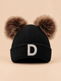 Gorro negro de mujer de tejido polar con letra D y orejas decorativas suaves, fotografiado de frente