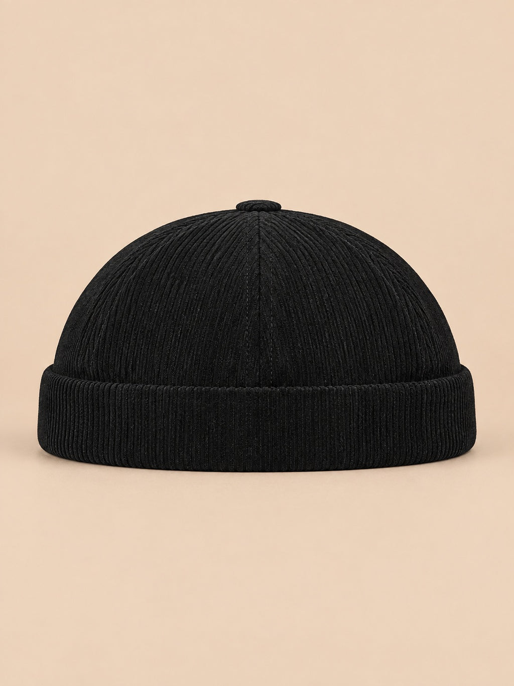 Gorro sin ala de pana a rayas para entretiempo, color negro, vista frontal, sobre fondo color arena y melocotón