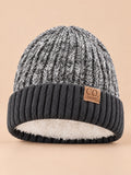 Bonnet de ski doublé en maille grise, vue de face sur fond beige