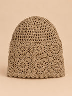 Bonnet turban femme kaki ajouré à fleurs au crochet, vue de face sur fond pêche sable